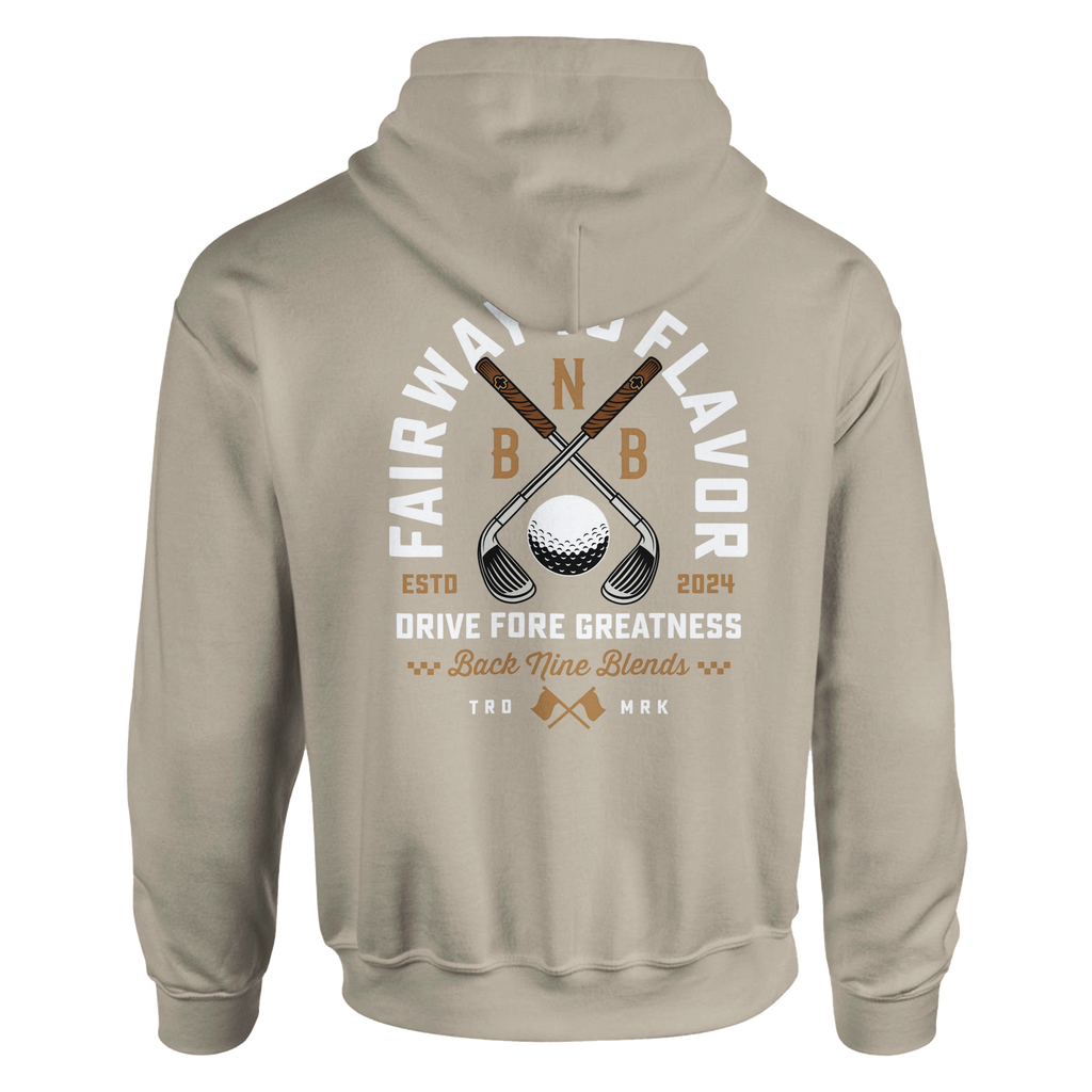 A sand pullover hoodie featuring a bold graphic of crossed golf clubs and a golf ball, with arced white text 'FAIRWAY TO FLAVOR' above, and 'DRIVE FORE GREATNESS' below.